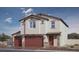 Inviting two-story home with desert landscaping, tile roof, and red garage doors at 1194 Dre Harbor Pl # Lot 87, North Las Vegas, NV 89084