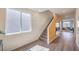 Hallway with staircase and wood-look flooring that leads into an open living area with mirrors at 1194 Dre Harbor Pl # Lot 87, North Las Vegas, NV 89084