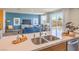 Contemporary kitchen island with double sinks and a view of the open-concept living area and backyard access at 1194 Dre Harbor Pl # Lot 87, North Las Vegas, NV 89084