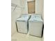 A laundry room with tile floors, window and white washer and dryer at 12021 Spice Tree St, Las Vegas, NV 89183