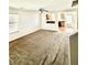 Open-concept living room area with carpet and pass through window to kitchen at 12021 Spice Tree St, Las Vegas, NV 89183