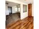 Open-concept living room area with hardwood floors and pass through to carpeted area at 12021 Spice Tree St, Las Vegas, NV 89183
