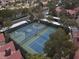 Aerial view showcasing community tennis and basketball courts surrounded by lush trees at 2200 S Fort Apache Rd # 1101, Las Vegas, NV 89117