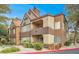 Condominium exterior featuring multiple balconies, red tile roofing, and professionally landscaped grounds at 2200 S Fort Apache Rd # 1101, Las Vegas, NV 89117