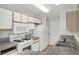 White kitchen featuring granite counters, white appliances, and double basin stainless steel sink at 2200 S Fort Apache Rd # 1101, Las Vegas, NV 89117
