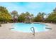 Resort-style pool with a small waterfall, lush landscaping, palm trees and lounge chairs at 2200 S Fort Apache Rd # 1101, Las Vegas, NV 89117
