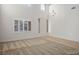 Spacious living room features an entry door, carpet, hard wood floor and large bright window with shutters at 2204 Ambermill Ct, Henderson, NV 89052