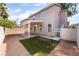 View of home's backyard with covered patio and low-maintenance desert landscaping at 2400 Dutchmans Pipe Ct, Las Vegas, NV 89106