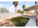 Backyard with covered patio and low-maintenance desert landscaping and turf at 2400 Dutchmans Pipe Ct, Las Vegas, NV 89106