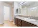 Bright bathroom with double vanity sinks, granite countertops, and tiled shower at 2400 Dutchmans Pipe Ct, Las Vegas, NV 89106