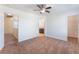 Spacious carpeted bedroom with ceiling fan, access to bathroom and walk-in closet at 2400 Dutchmans Pipe Ct, Las Vegas, NV 89106