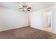Large bedroom with a ceiling fan and access to a hallway and a bathroom at 2400 Dutchmans Pipe Ct, Las Vegas, NV 89106