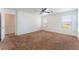 Spacious carpeted bedroom features ceiling fan and three sunny windows at 2400 Dutchmans Pipe Ct, Las Vegas, NV 89106