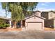 Charming two-story home with a well-maintained lawn and two car garage at 2400 Dutchmans Pipe Ct, Las Vegas, NV 89106