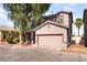 Two-story home featuring a two-car garage with a well-kept front yard at 2400 Dutchmans Pipe Ct, Las Vegas, NV 89106