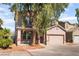 Inviting two-story home with a two-car garage and mature landscaping at 2400 Dutchmans Pipe Ct, Las Vegas, NV 89106