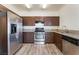 Kitchen features stainless steel appliances, granite countertops, and wood flooring at 2400 Dutchmans Pipe Ct, Las Vegas, NV 89106