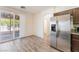 Eat-in kitchen features stainless steel refrigerator and sliding glass door to backyard at 2400 Dutchmans Pipe Ct, Las Vegas, NV 89106