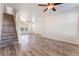 Spacious living area with laminate floors, a staircase, and lots of natural light at 2400 Dutchmans Pipe Ct, Las Vegas, NV 89106