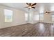 Bright living room featuring wood flooring, modern ceiling fans and large windows at 2400 Dutchmans Pipe Ct, Las Vegas, NV 89106
