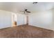 Large carpeted main bedroom features ceiling fan and ensuite bathroom at 2400 Dutchmans Pipe Ct, Las Vegas, NV 89106