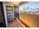View of the balcony with wooden floors, an outdoor storage closet, and a shelf for outdoor organization at 2451 N Rainbow Blvd # 1116, Las Vegas, NV 89108