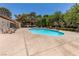 A clear view of the clean community pool with lounge chairs and mature shade trees around the pool area at 2451 N Rainbow Blvd # 1116, Las Vegas, NV 89108