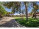 An exterior shot of the apartments, a grassy area, mature trees, and picnic tables at 2451 N Rainbow Blvd # 1116, Las Vegas, NV 89108