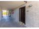 Exterior hallway view of unit 1116 with a welcome mat and a dark wooden front door at 2451 N Rainbow Blvd # 1116, Las Vegas, NV 89108
