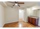 Spacious living room featuring hard wood flooring, a ceiling fan, and a wet bar at 2451 N Rainbow Blvd # 1116, Las Vegas, NV 89108