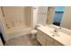Bright bathroom with a bathtub-shower combination, white vanity, and tile flooring at 3930 Starfield Ln, Las Vegas, NV 89147