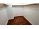 Walk-in closet providing ample storage with built-in shelving and dark hardwood floors for organized elegance at 3930 Starfield Ln, Las Vegas, NV 89147