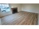 Spacious living room featuring modern wood flooring and a cozy fireplace, perfect for relaxing and entertaining guests at 3930 Starfield Ln, Las Vegas, NV 89147