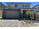 Charming two-story home boasts a brick-paved driveway and inviting covered entryway at 560 Preston Oak Pl, Las Vegas, NV 89138