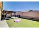 Lawn backyard featuring a covered patio with seating, a BBQ and outdoor storage space at 5929 Caddy Ridge St, North Las Vegas, NV 89031