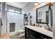 Bathroom with a walk-in shower and a black vanity with a marble countertop at 5929 Caddy Ridge St, North Las Vegas, NV 89031