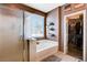 Bathroom featuring a tub with shower and a walk-in closet at 5929 Caddy Ridge St, North Las Vegas, NV 89031