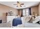 Comfortable bedroom with a ceiling fan, white furniture and carpeted floors at 5929 Caddy Ridge St, North Las Vegas, NV 89031