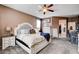 Bedroom featuring a neutral color scheme, a ceiling fan and a doorway leading to the bathroom at 5929 Caddy Ridge St, North Las Vegas, NV 89031