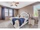 Bedroom with a tufted headboard, carpet, and large windows at 5929 Caddy Ridge St, North Las Vegas, NV 89031