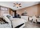 Bedroom with a ceiling fan, white furniture, carpeted floors and open doorway at 5929 Caddy Ridge St, North Las Vegas, NV 89031