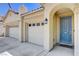 A cozy home with a convenient three-car garage and an inviting, arched entryway at 5929 Caddy Ridge St, North Las Vegas, NV 89031