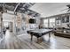 Spacious game room with a pool table, a large TV, and fan-themed decor at 5929 Caddy Ridge St, North Las Vegas, NV 89031