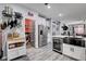 Open concept kitchen with stainless steel appliances, wine fridge, and gray wood floors at 5929 Caddy Ridge St, North Las Vegas, NV 89031
