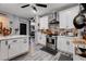 Kitchen featuring white cabinets, tile backsplash, stainless appliances, gray wood floors at 5929 Caddy Ridge St, North Las Vegas, NV 89031