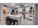 Open kitchen with granite counters, stainless appliances, gray wood floors, and stone island at 5929 Caddy Ridge St, North Las Vegas, NV 89031