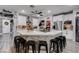 A kitchen featuring white cabinets, a center island with seating, stainless steel appliances, and a pantry at 5929 Caddy Ridge St, North Las Vegas, NV 89031