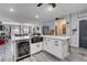 Kitchen island with wine fridge, marble countertop and a stainless sink with an open living room at 5929 Caddy Ridge St, North Las Vegas, NV 89031