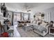 Open living room with large windows, wood floors, and ample seating at 5929 Caddy Ridge St, North Las Vegas, NV 89031