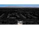 An elevated view of a home with solar panels, set against a darked urban and mountain landscape at 6236 Foothill Blvd, Las Vegas, NV 89118